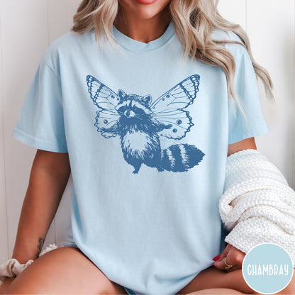 Comfort Colors tee in Chambray featuring whimsical graphic style of a raccoon with large detailed butterfly wings