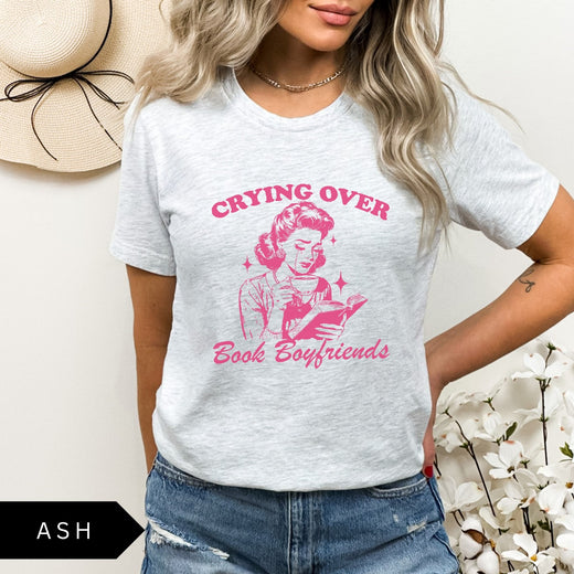 Comfort Colors tee in Ash featuring retro style graphic of a woman crying while reading a book
