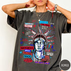 Comfort Colors tee in Pepper featuring grunge style Statue of Liberty graphic with patriotic red and blue text