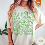 Comfort Colors tee in Ivory featuring line art style St. Patrick's Day icons including shamrocks and leprechaun hat
