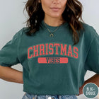 Comfort Colors tee in Blue Spruce featuring Christmas holiday theme graphic with red and green text design
