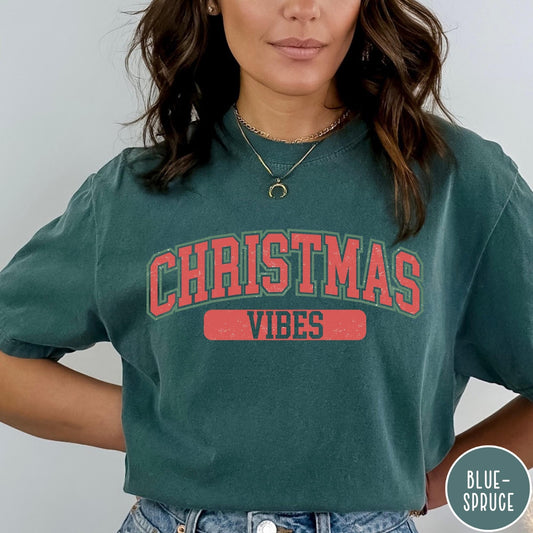 Comfort Colors tee in Blue Spruce featuring Christmas holiday theme graphic with red and green text design