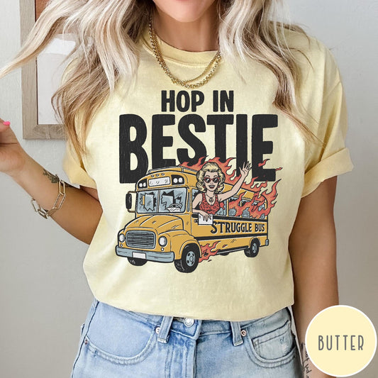 Comfort Colors tee in Butter featuring retro style graphic of a woman waving from a burning school bus