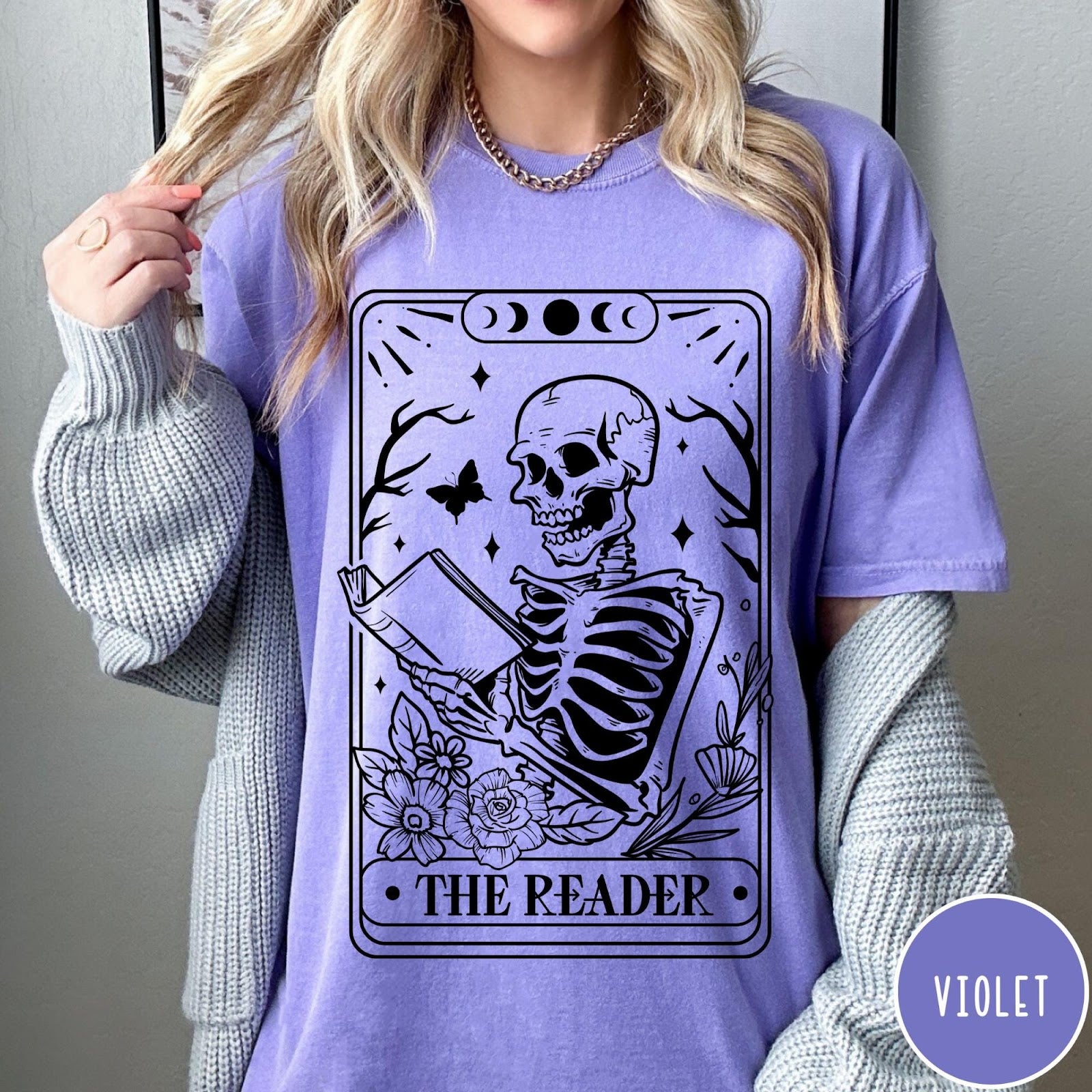 Comfort Colors tee in Violet featuring tarot card style graphic of a skeleton reading a book