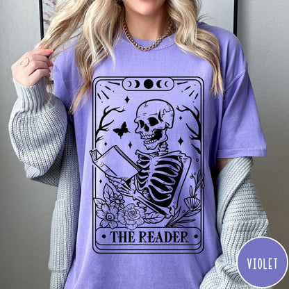 Comfort Colors tee in Violet featuring tarot card style graphic of a skeleton reading a book