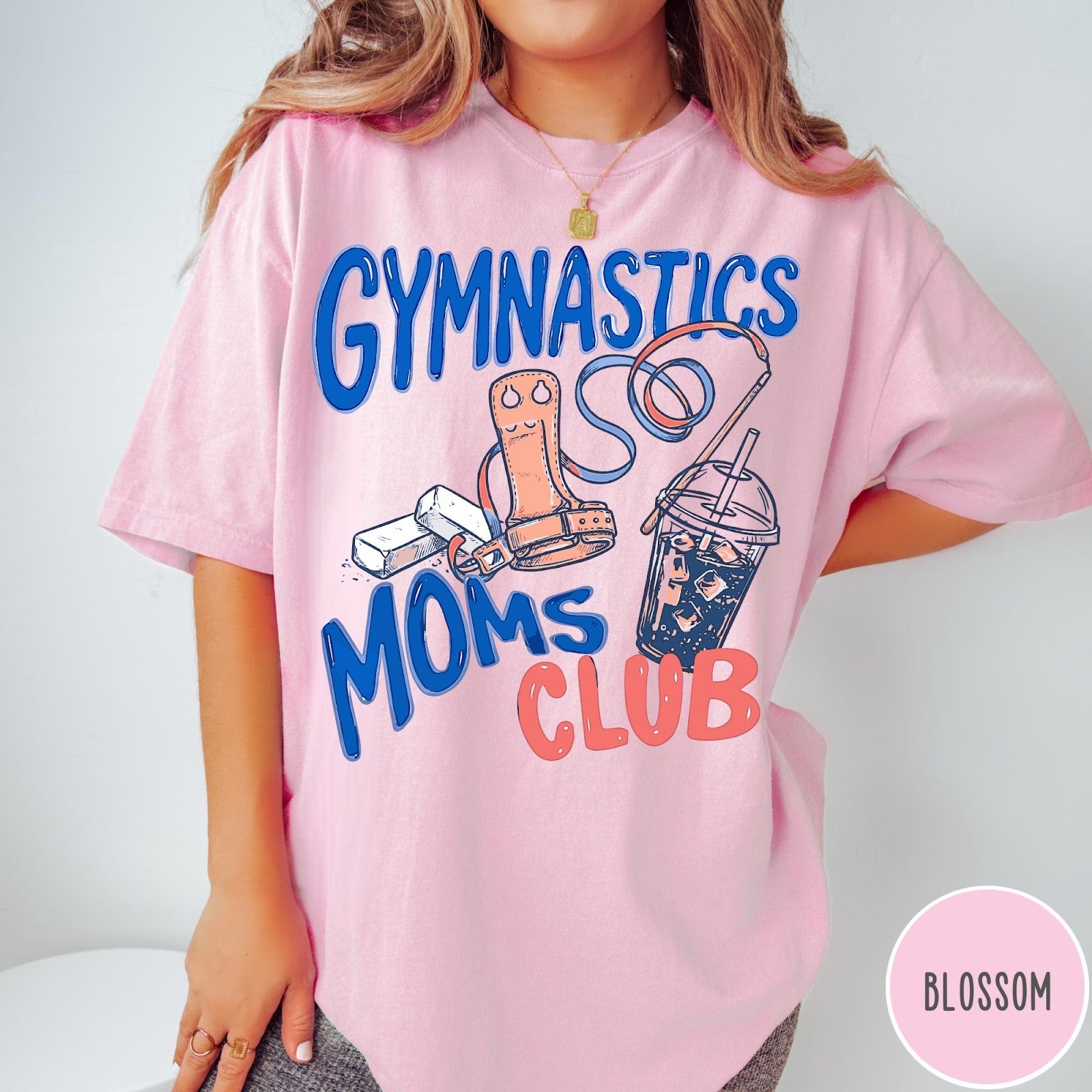 Comfort Colors tee in Blossom featuring gymnastics mom life graphic with grips, chalk, and iced coffee