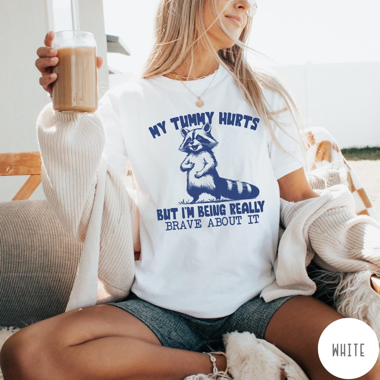 Comfort Colors tee in White featuring graphic illustration of a standing raccoon with funny text about being brave
