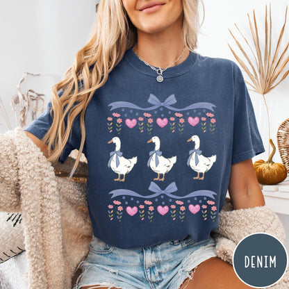Comfort Colors tee in Denim featuring vintage style graphic with three geese wearing blue bows and hearts