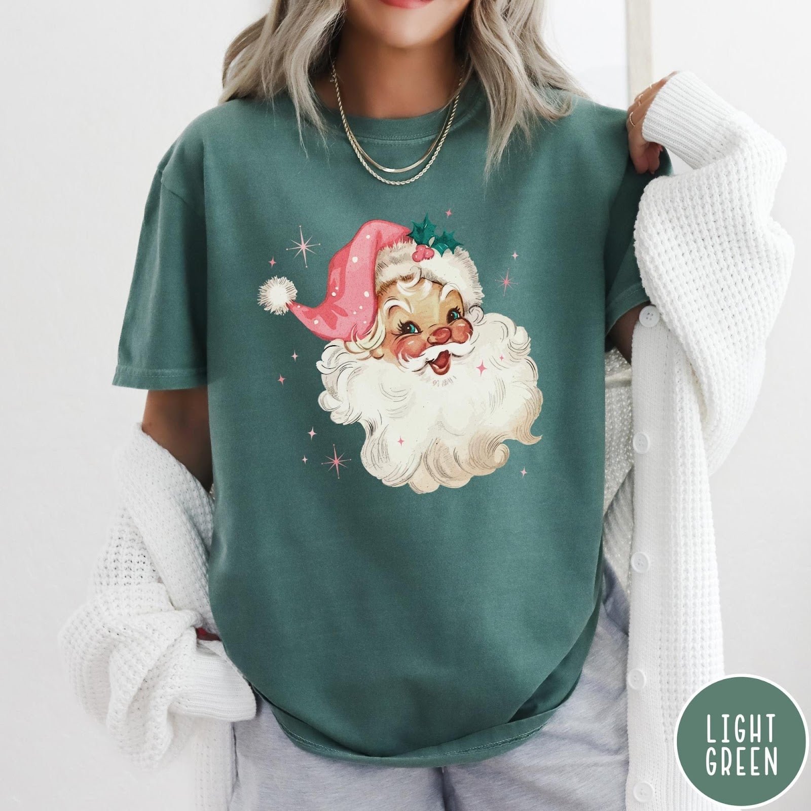 Comfort Colors tee in Light Green featuring retro Christmas style graphic of a smiling Santa Claus with pink hat