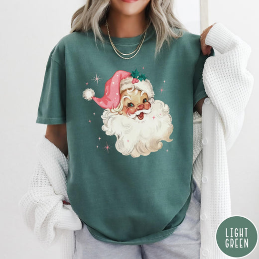 Comfort Colors tee in Light Green featuring retro Christmas style graphic of a smiling Santa Claus with pink hat