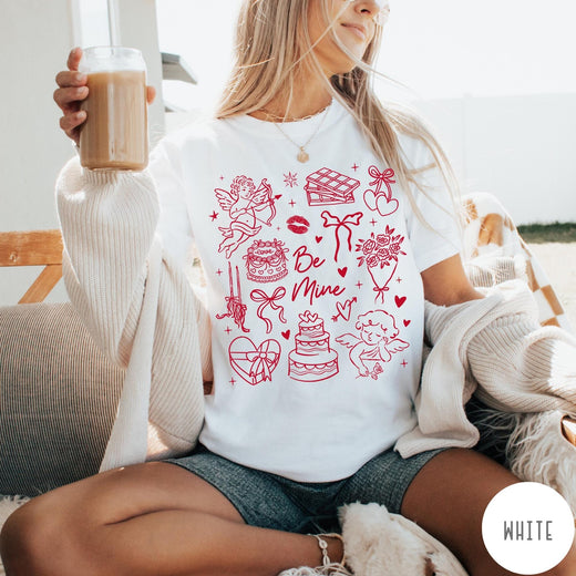 Comfort Colors tee in White featuring Valentine's Day collage design with cupid, cake, flowers, and chocolate graphics