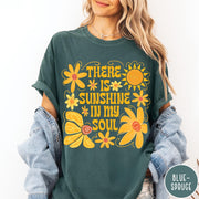 Comfort Colors tee in Blue Spruce featuring inspirational quote design with yellow flowers and a sun graphic