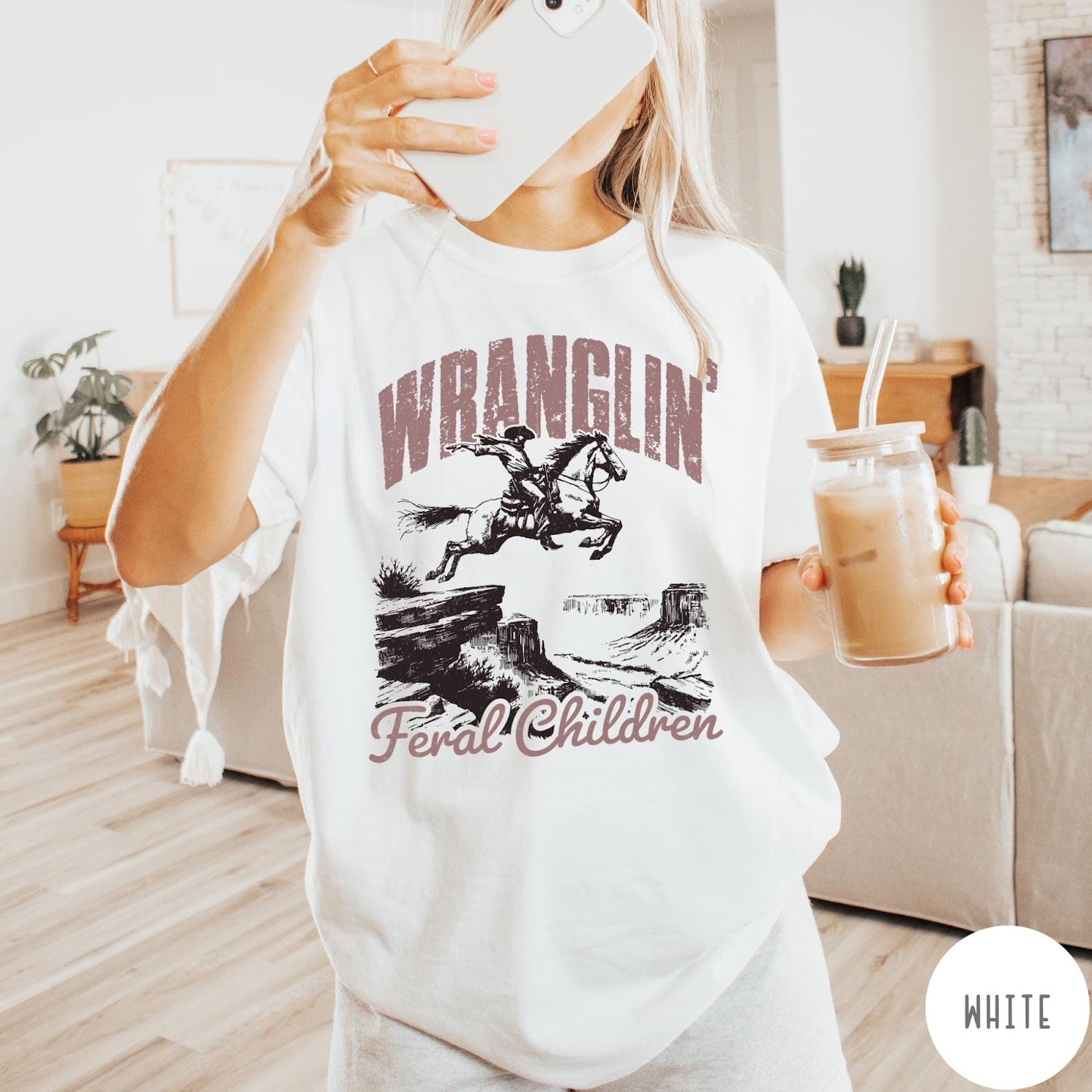 Comfort Colors tee in White featuring western style graphic of a cowboy on horseback jumping a canyon