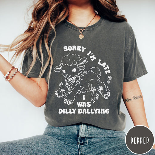 Comfort Colors tee in Pepper featuring line art graphic of a lamb with flowers and text