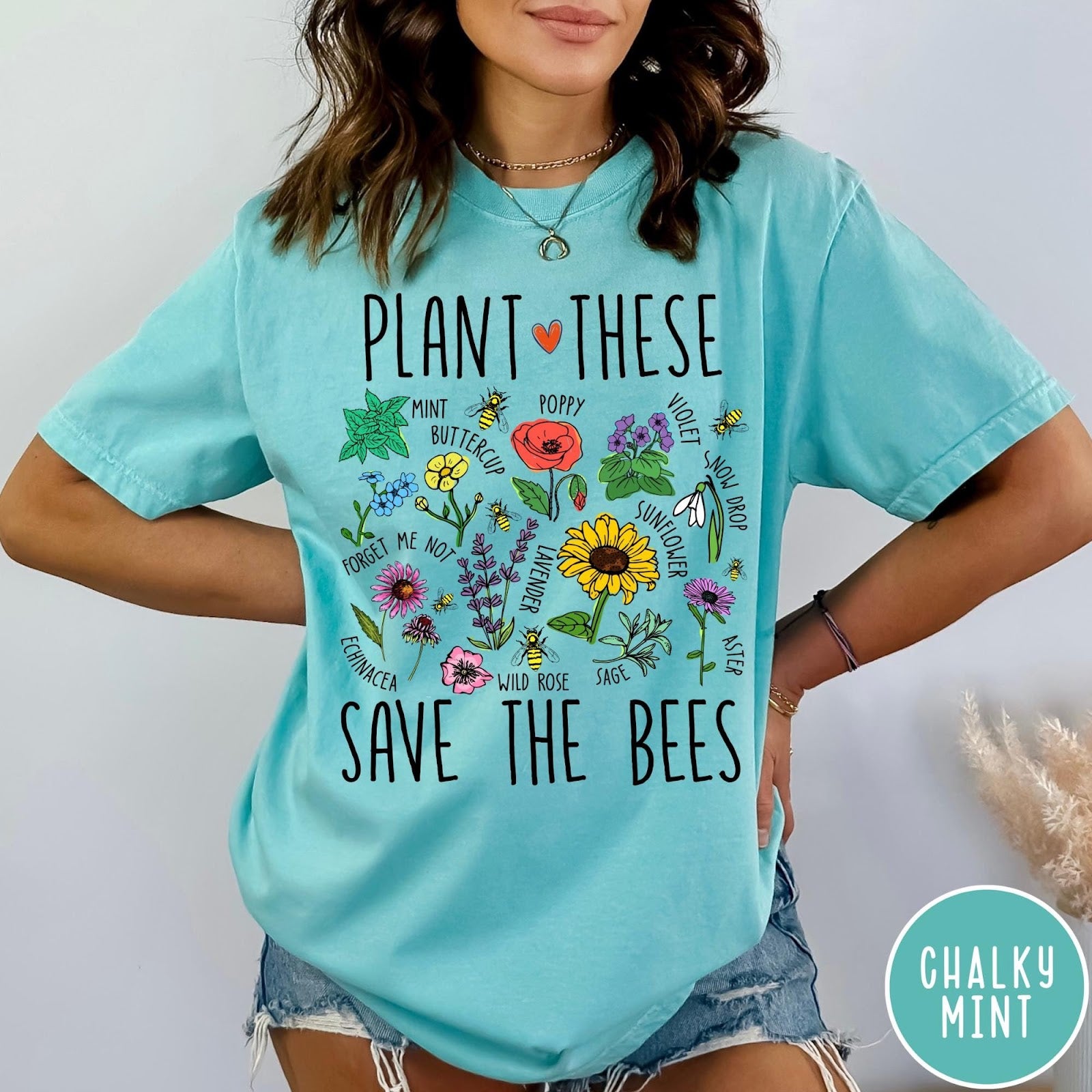 Comfort Colors tee in Chalky Mint featuring botanical garden style graphic with various flowers and bees