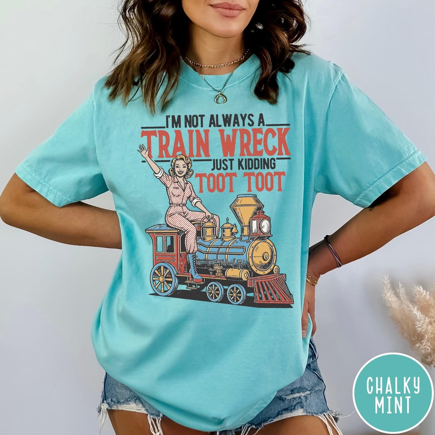 Comfort Colors tee in Chalky Mint featuring vintage pin-up style graphic of a woman riding a steam train