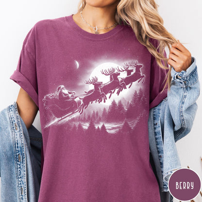 Comfort Colors tee in Berry featuring vintage style graphic of Santa Claus flying his sleigh with reindeer