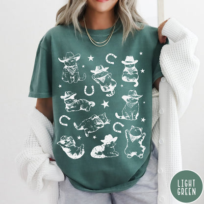 Comfort Colors tee in Light Green featuring western graphic style with multiple cowboy kittens and horseshoe illustrations