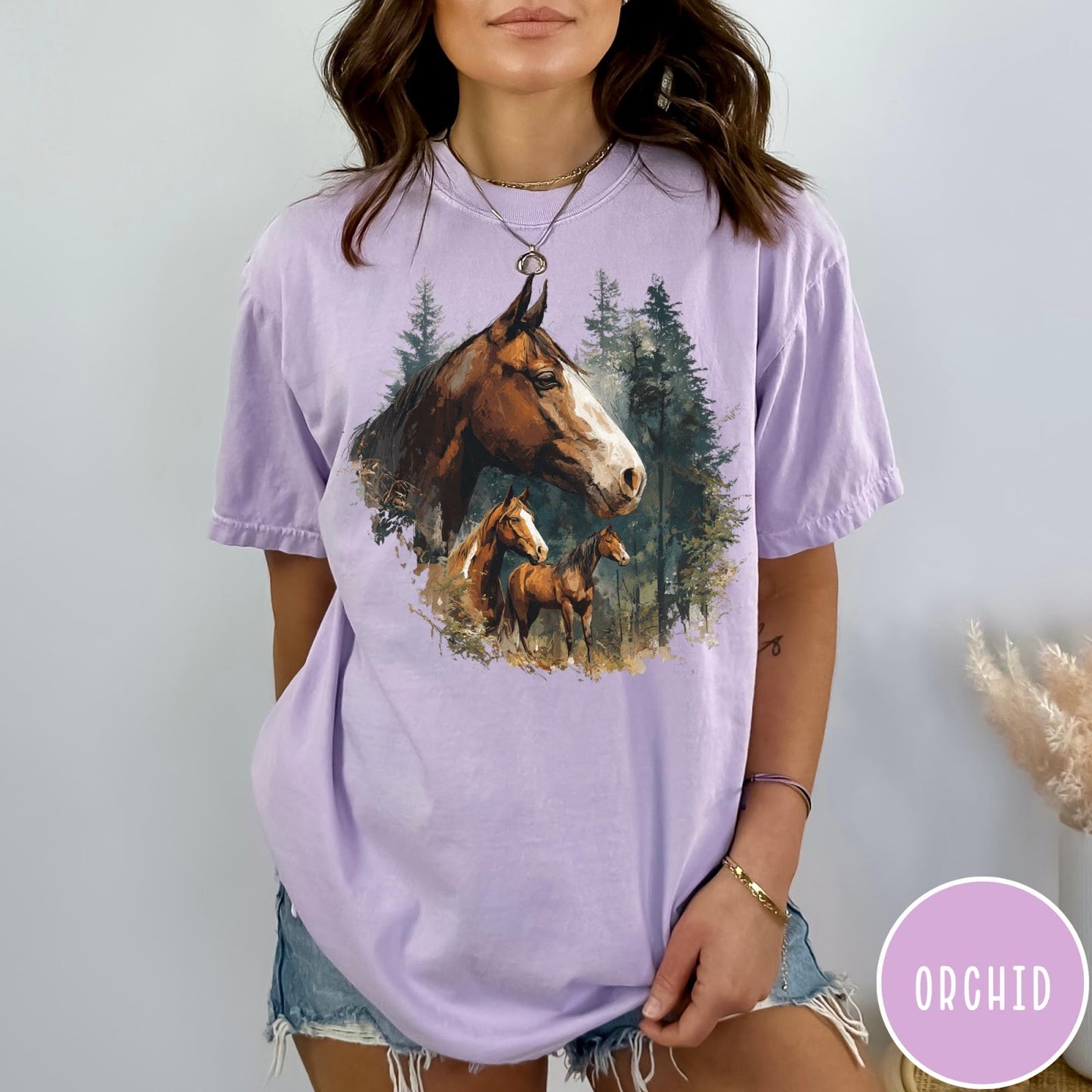 Comfort Colors tee in Orchid featuring vintage style graphic of three horses standing in a pine forest