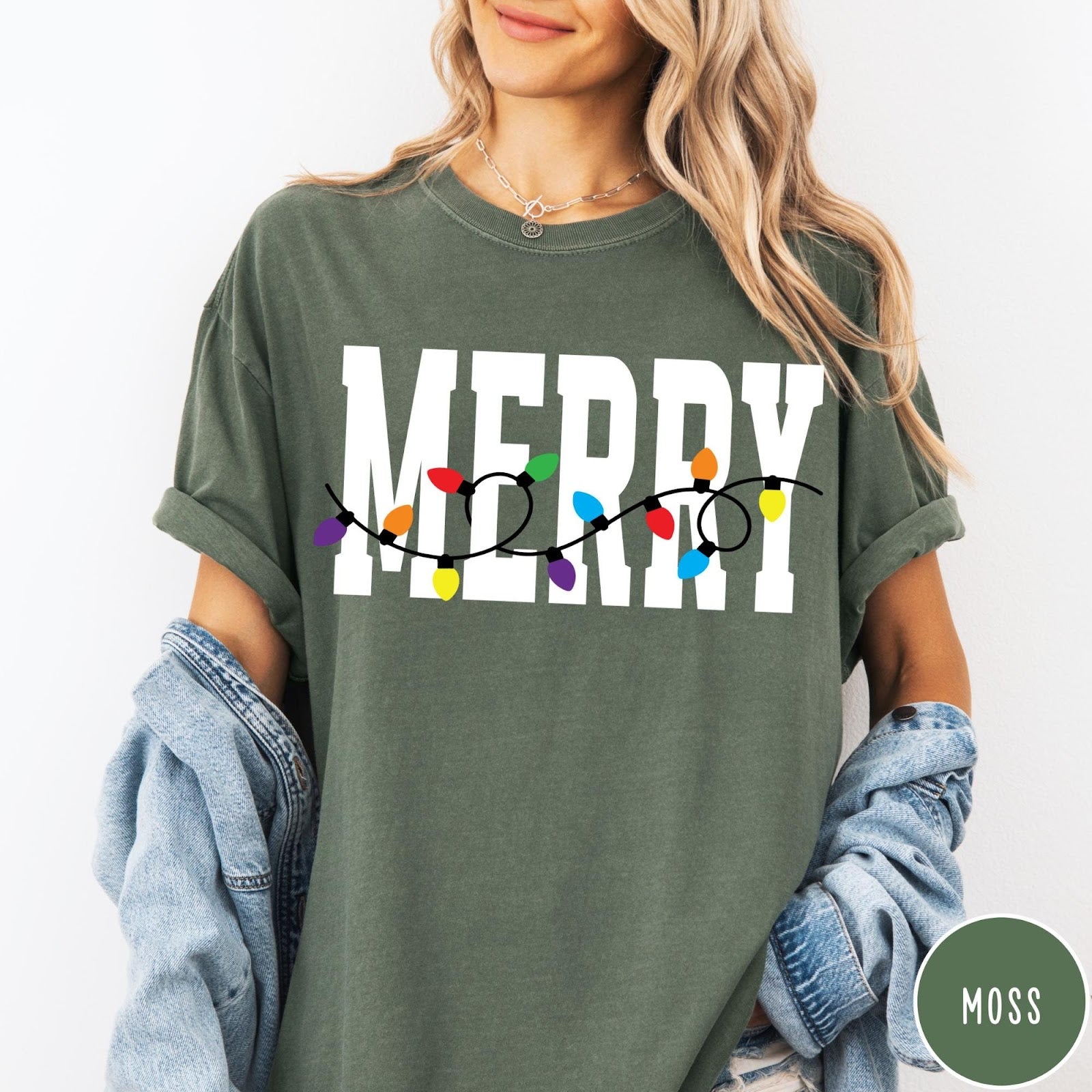Comfort Colors tee in Moss featuring festive holiday style graphic with Merry text and Christmas lights