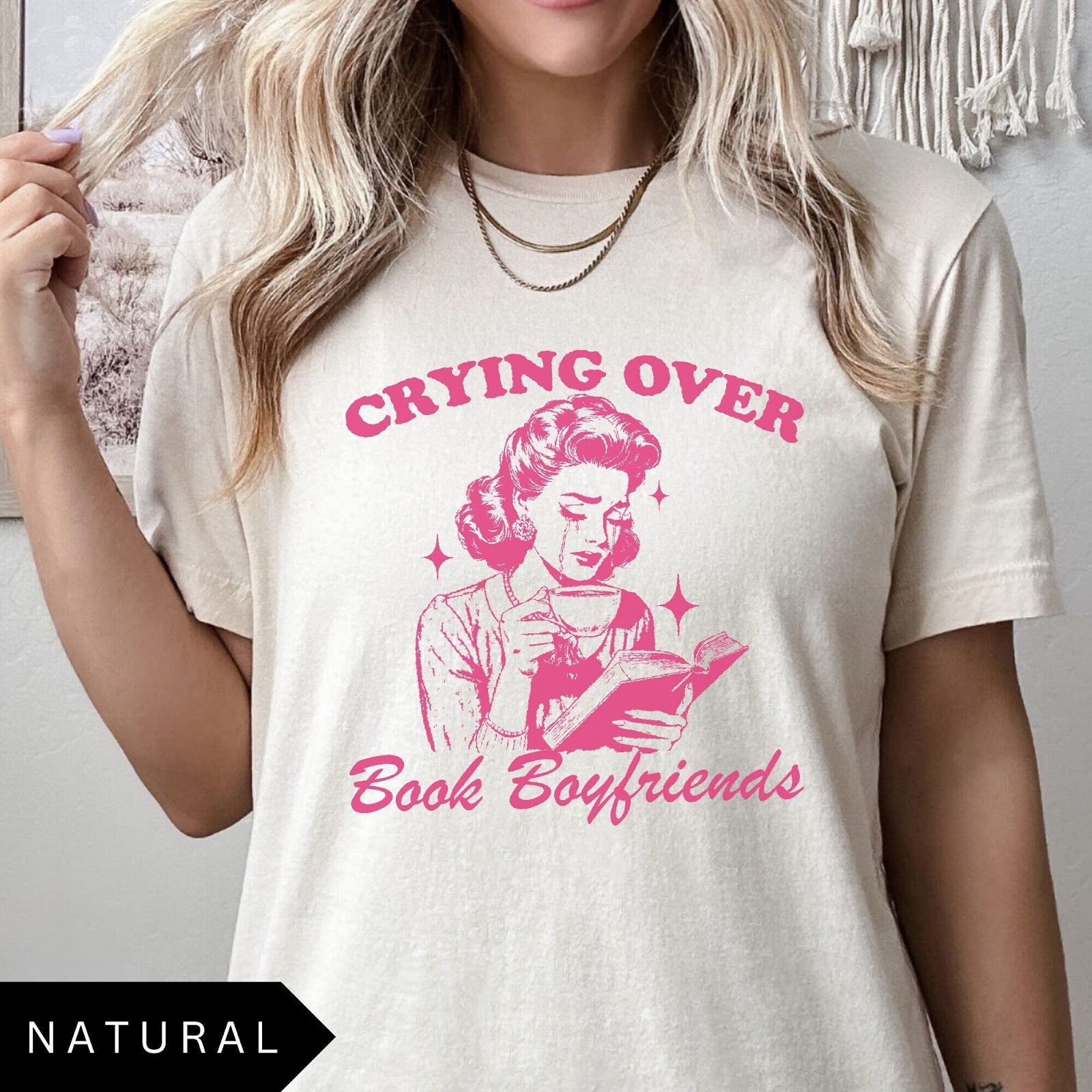 Comfort Colors tee in Natural featuring retro style graphic of a woman crying while reading a book