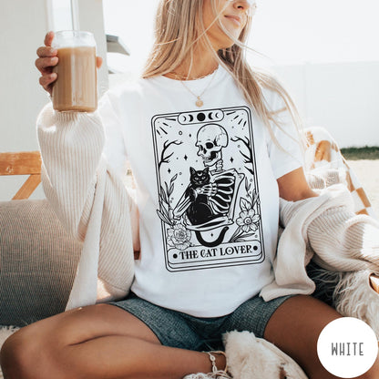 Comfort Colors tee in White featuring tarot style graphic of a skeleton holding a black cat