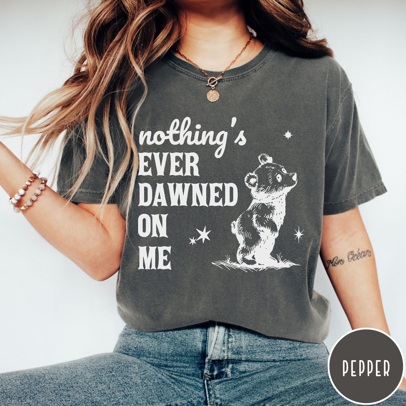 Comfort Colors tee in Pepper featuring illustrated style graphic of a small bear looking up at stars
