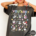 Comfort Colors tee in Pepper featuring cute cartoon duck graphic with inspirational words like kind and brave