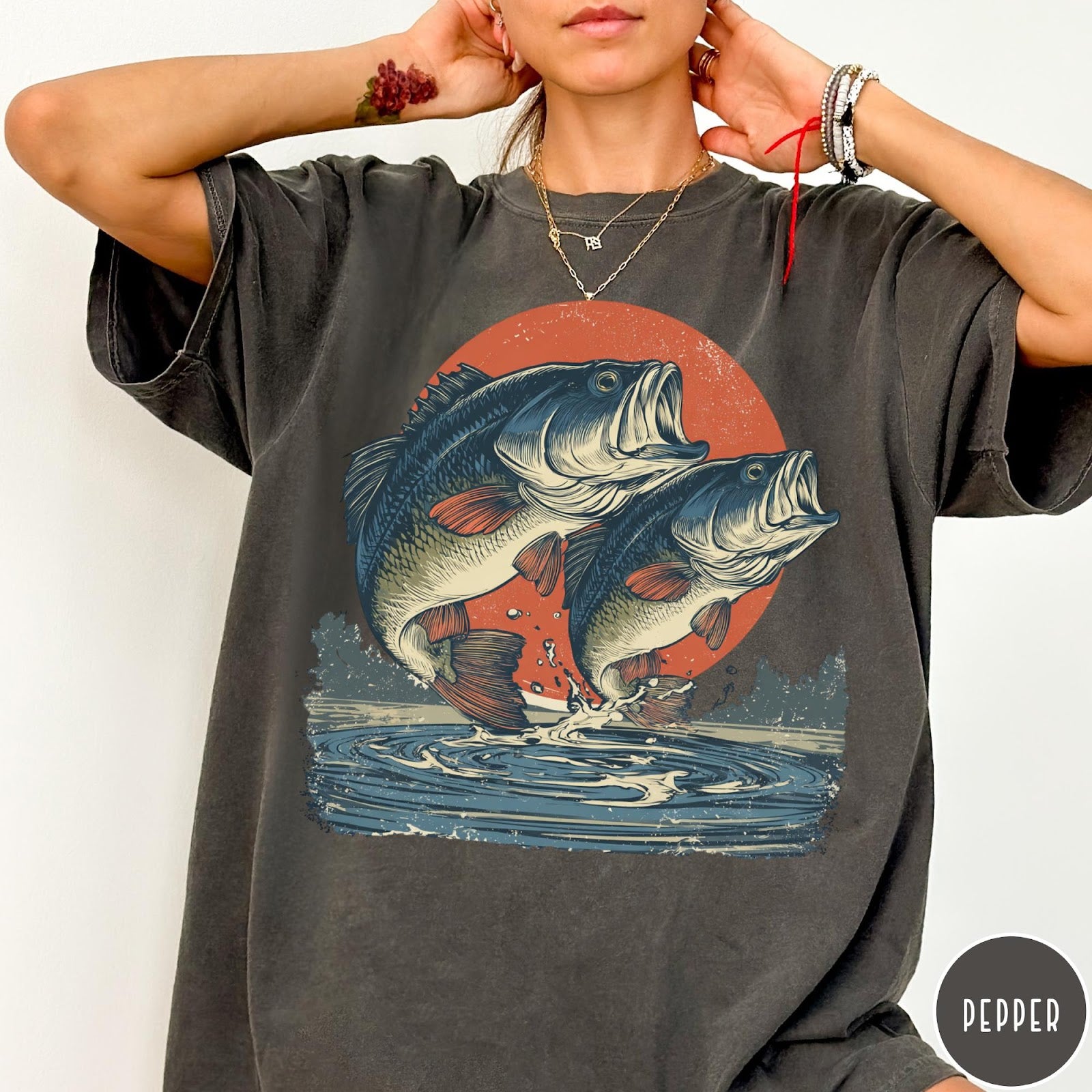 Comfort Colors tee in Pepper featuring vintage style graphic of two bass fish jumping from water