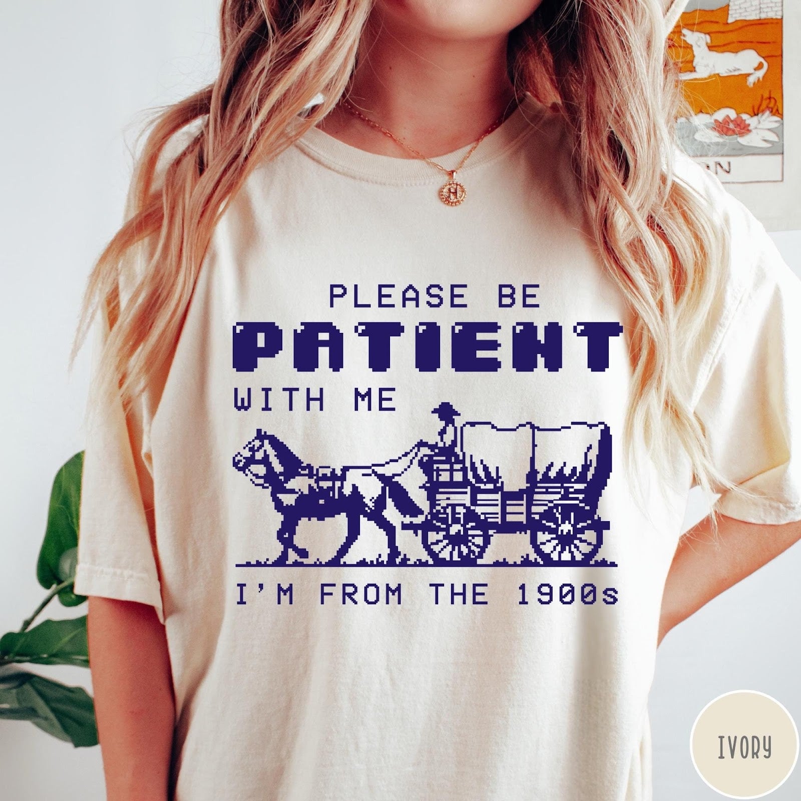 Comfort Colors tee in Ivory featuring pixel art style graphic of a horse drawn covered wagon