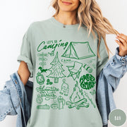 Comfort Colors tee in Bay featuring retro camping adventure collage graphic with tent, campfire, and outdoor icons
