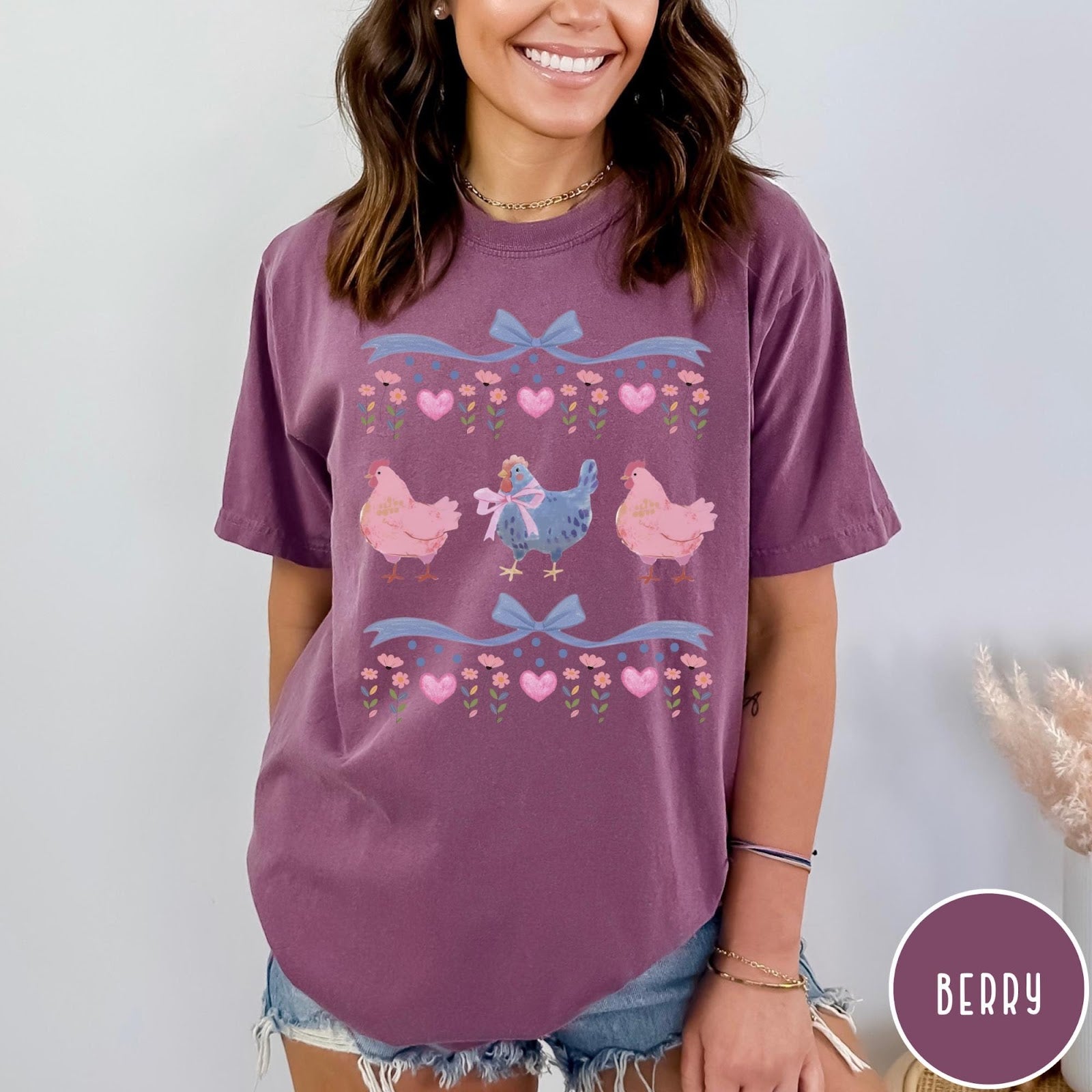 Comfort Colors tee in Berry featuring vintage style graphic with three chickens, floral accents, and blue bows