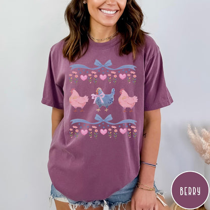 Comfort Colors tee in Berry featuring vintage style graphic with three chickens, floral accents, and blue bows