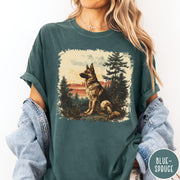 Comfort Colors tee in Blue Spruce featuring vintage style graphic of a German Shepherd sitting in a forest