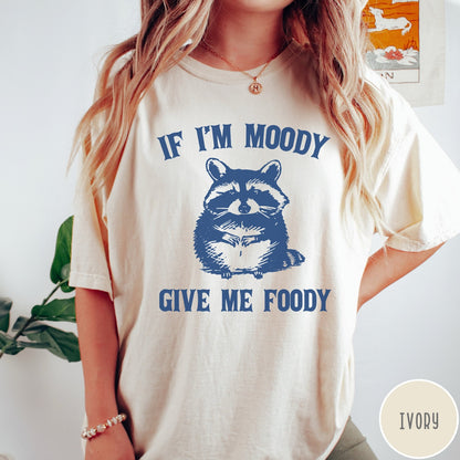Comfort Colors tee in Ivory featuring vintage style graphic of a raccoon with text If I'm Moody Give Me Foody