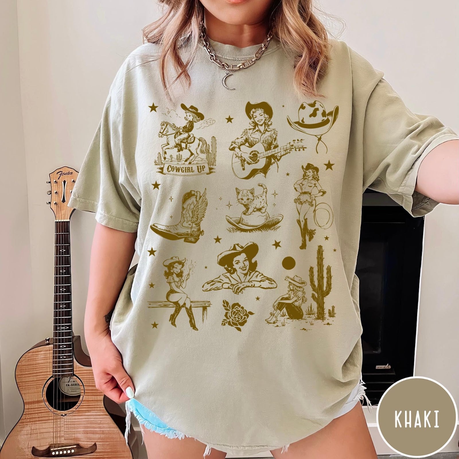 Comfort Colors tee in Khaki featuring retro western collage graphic with cowgirls, boots, and desert elements