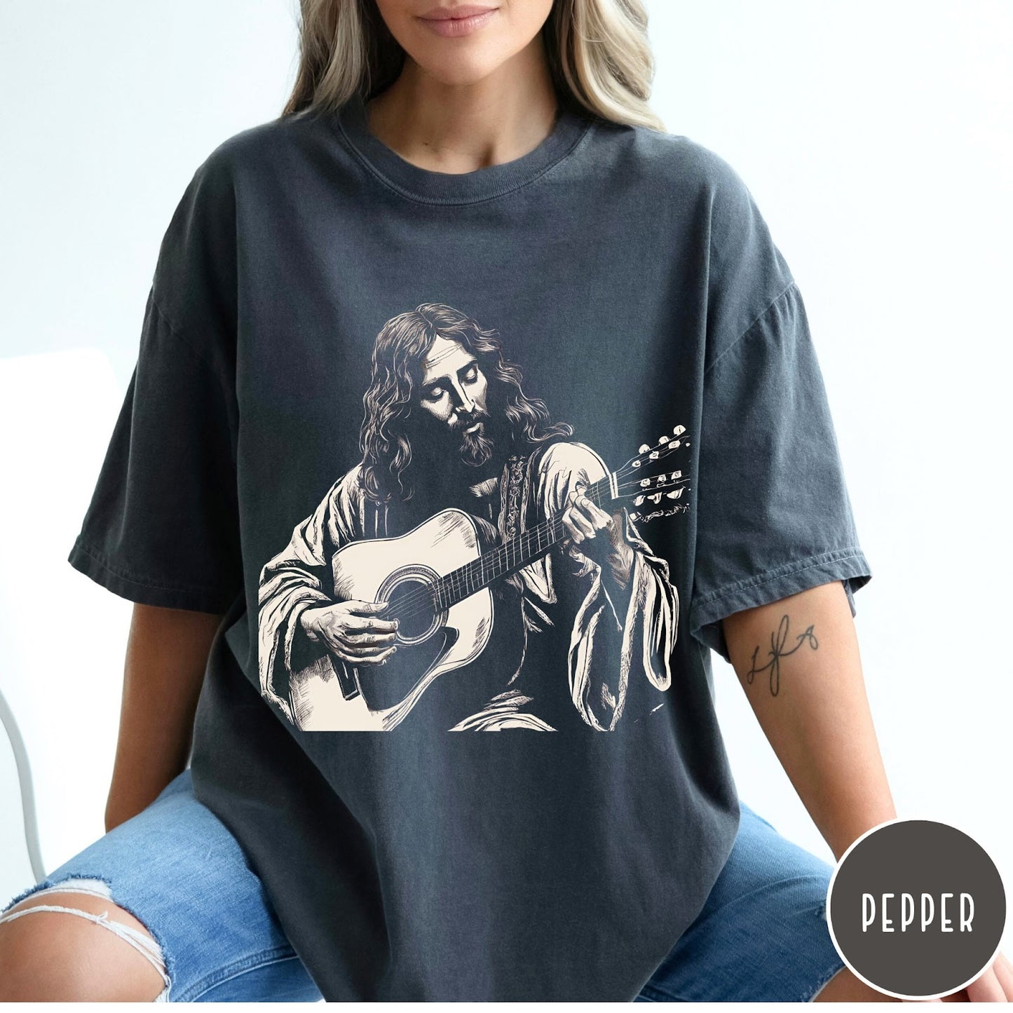 Comfort Colors tee in Pepper featuring vintage style graphic of Jesus playing an acoustic guitar