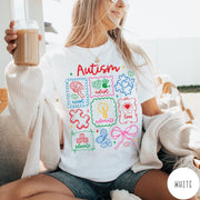 Comfort Colors tee in White featuring coquette style autism awareness graphic with puzzle pieces and colorful icons