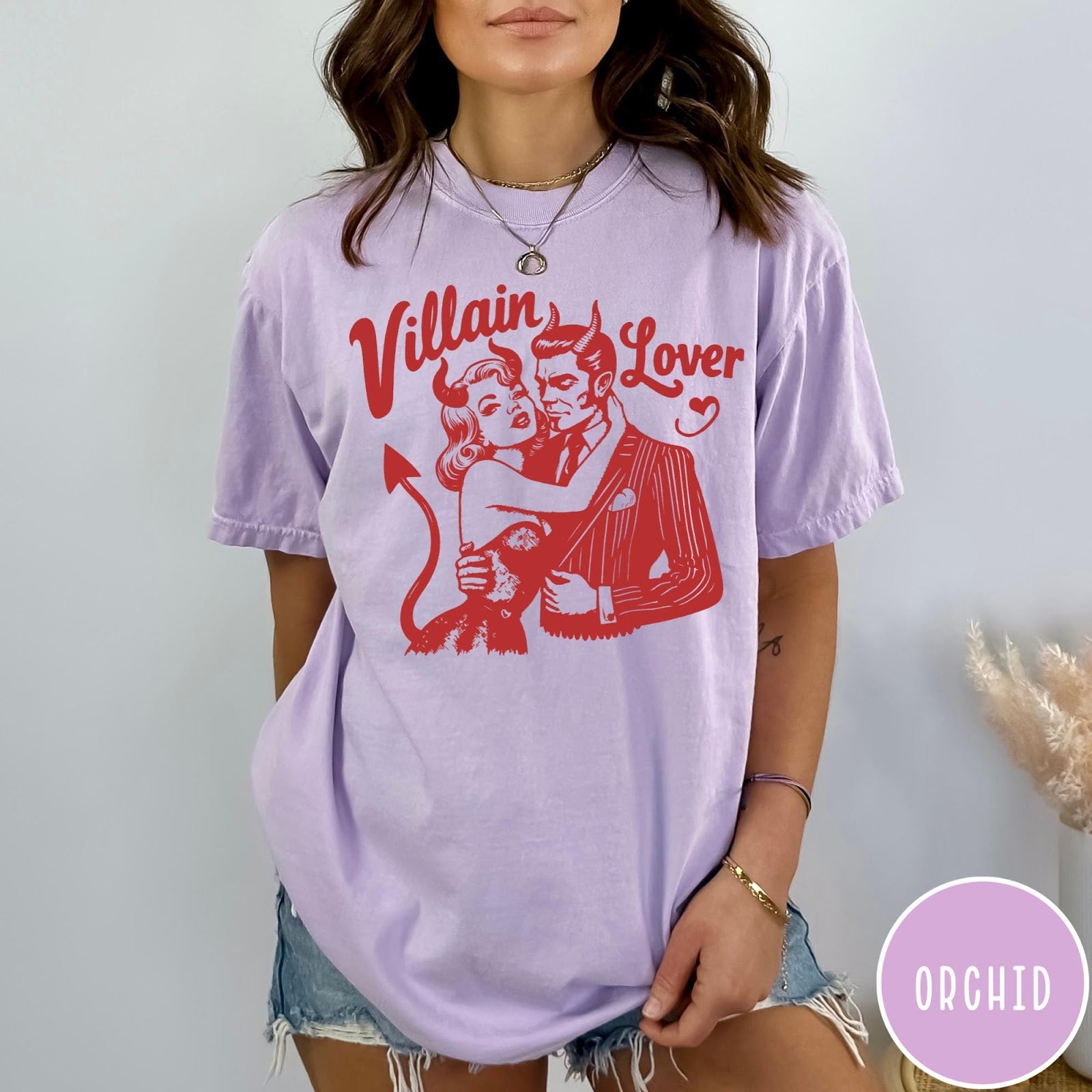 Comfort Colors tee in Orchid featuring vintage style graphic of a devilish couple embracing with red ink