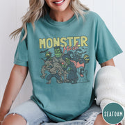 Comfort Colors tee in Seafoam featuring retro Halloween style graphic with various classic monsters and spooky characters