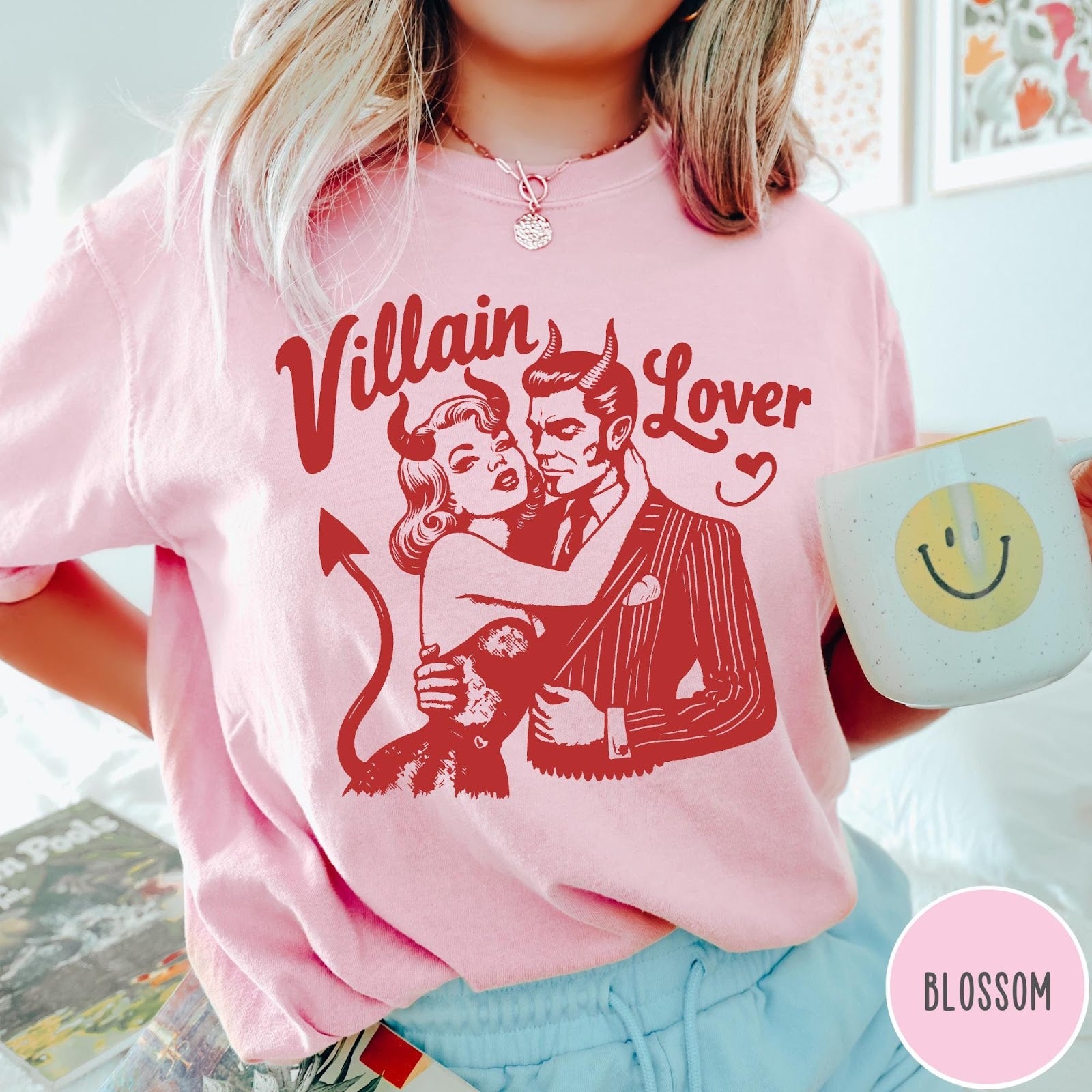 Comfort Colors tee in Blossom featuring vintage style graphic of a devilish couple embracing with red ink