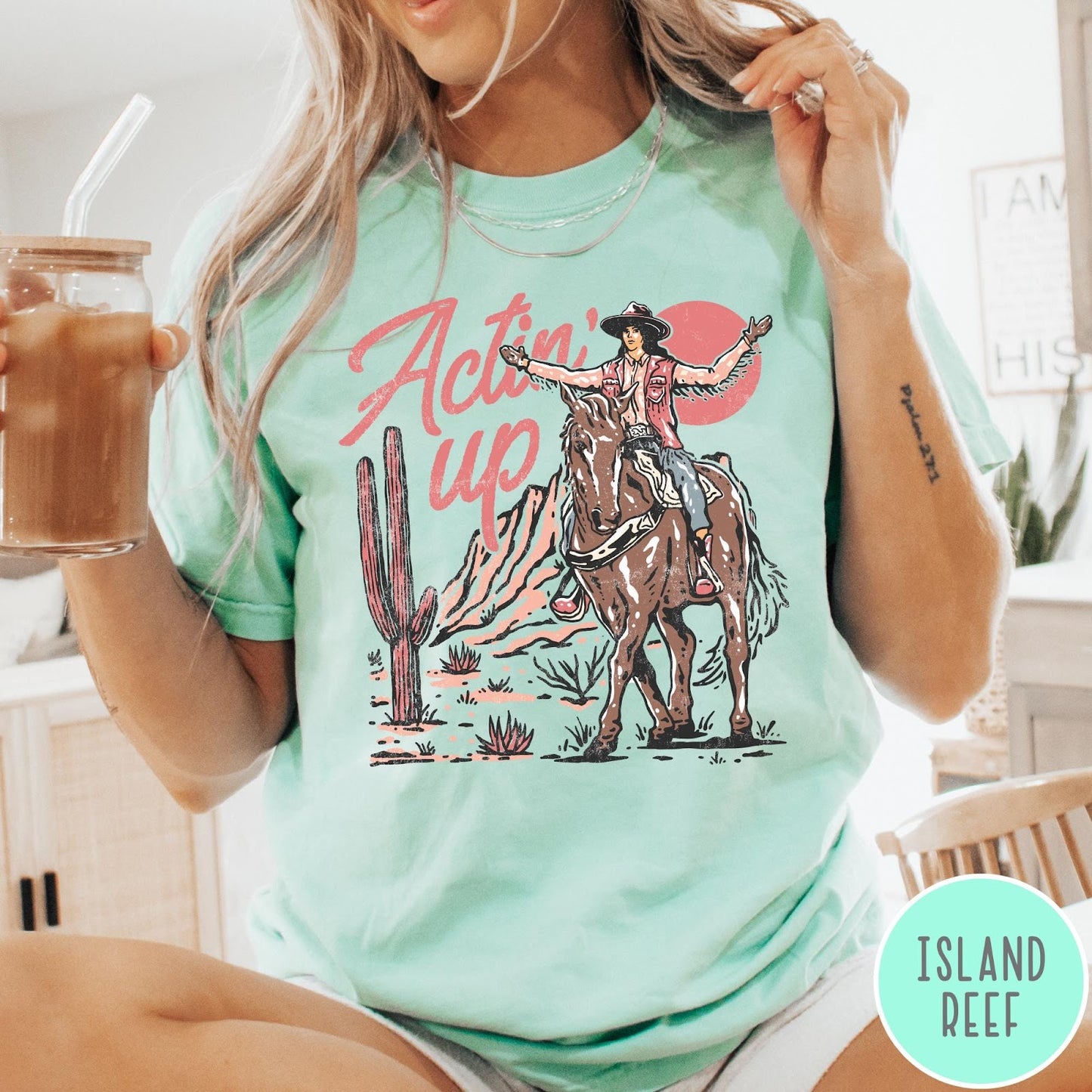 Comfort Colors tee in Island Reef featuring western style graphic of a cowgirl riding a horse in the desert