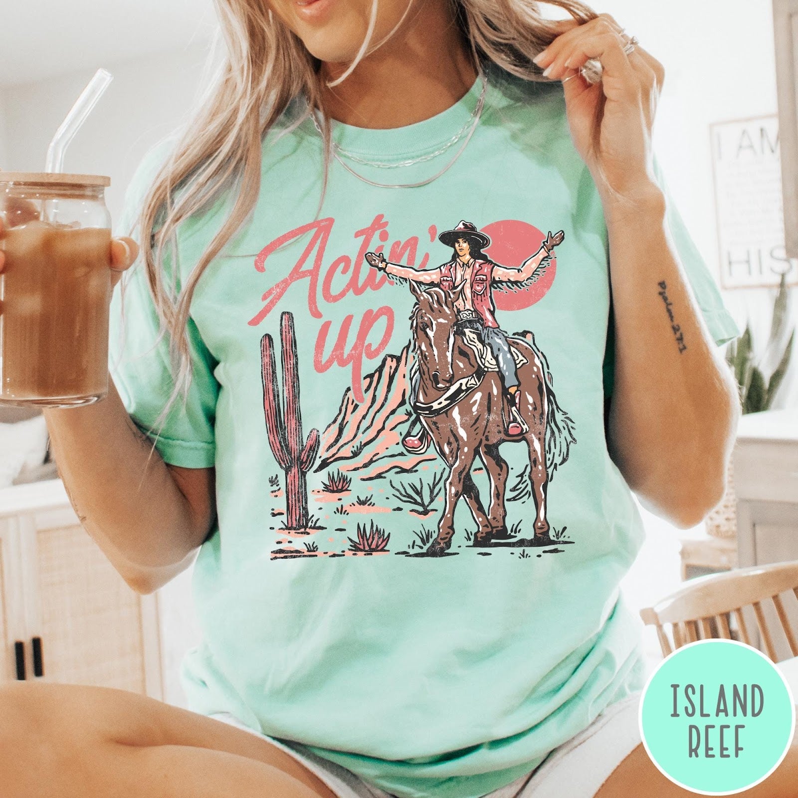 Comfort Colors tee in Island Reef featuring western style graphic of a cowgirl riding a horse in the desert
