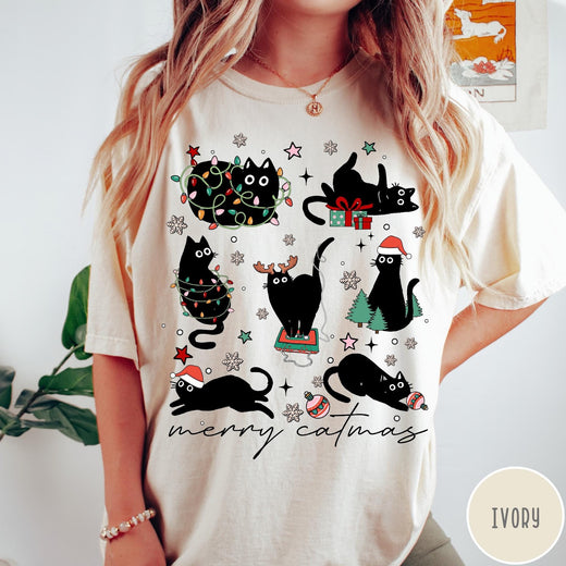 Comfort Colors tee in Ivory featuring festive holiday graphic with multiple black cats and Christmas elements
