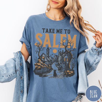 Comfort Colors tee in Blue Jean featuring vintage style Salem town scene with black cat and pumpkins