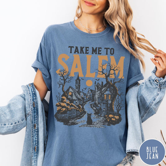 Comfort Colors tee in Blue Jean featuring vintage style Salem town scene with black cat and pumpkins