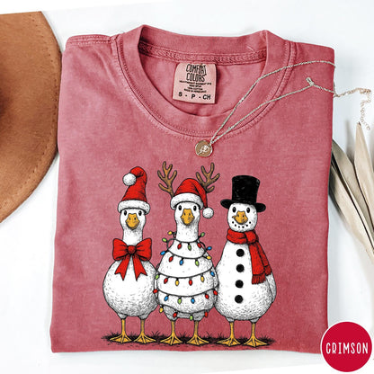 Comfort Colors tee in Crimson featuring festive holiday graphic of three geese dressed as Santa and snowman