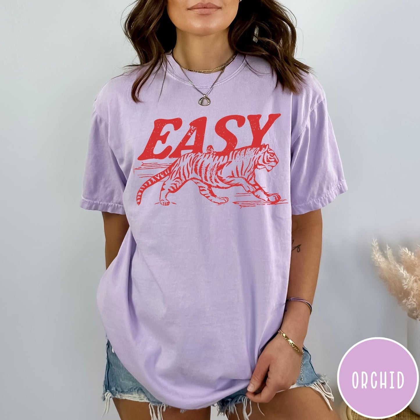 Comfort Colors tee in Orchid featuring vintage style graphic of a walking tiger and text Easy