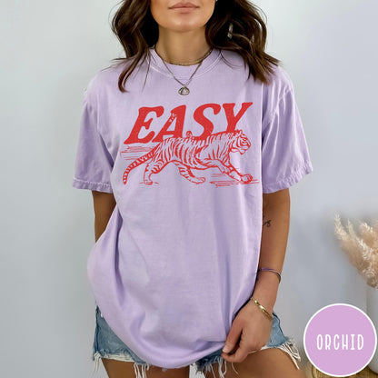 Comfort Colors tee in Orchid featuring vintage style graphic of a walking tiger and text Easy