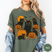 Comfort Colors tee in Moss featuring Halloween style graphic with black cats, pumpkins, bats, and fall leaves